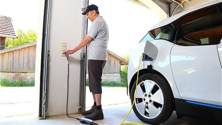 Person charging EV at home