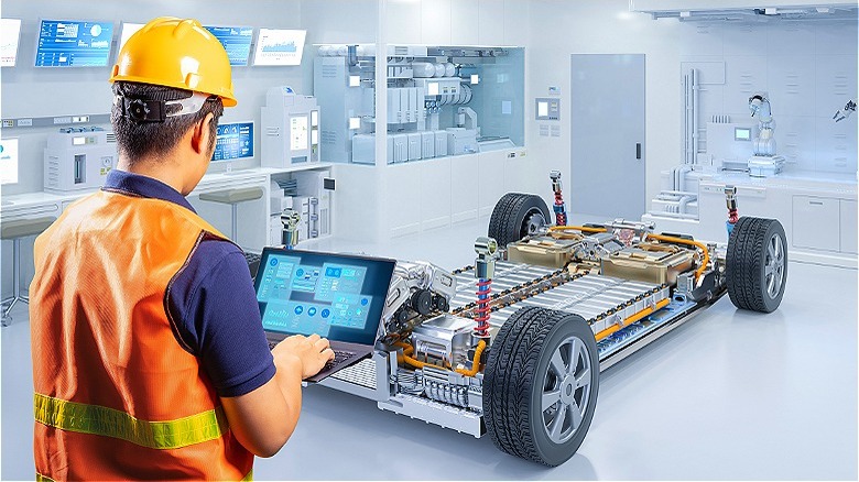 Worker examining EV in laboratory