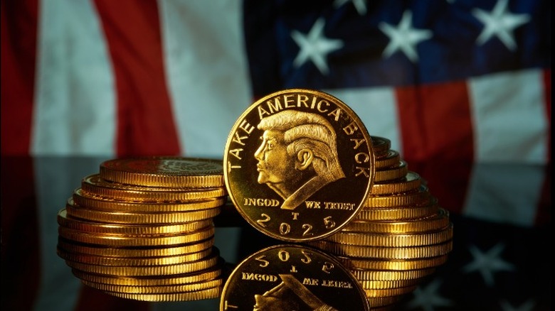 Novelty Trump coins positioned in front of an American flag.