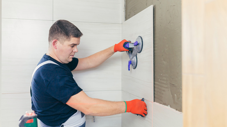 Tiler working in bathroom