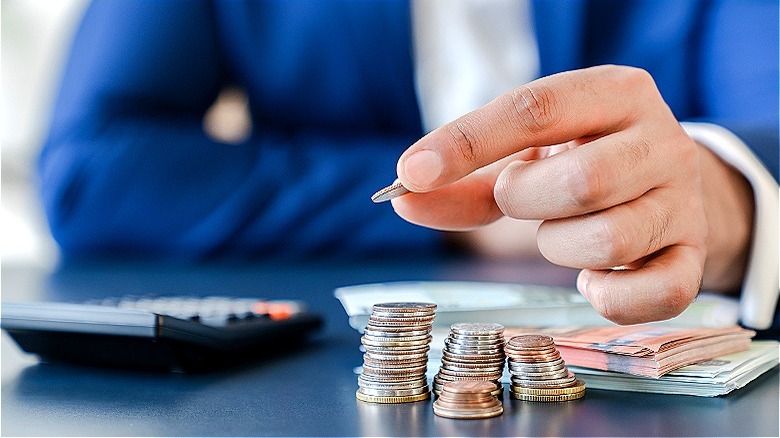 Money with hand holding coin