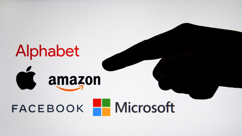 pointing at FAANG logos and Microsoft