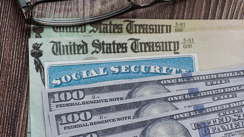 Social Security check, card, and $100 bills