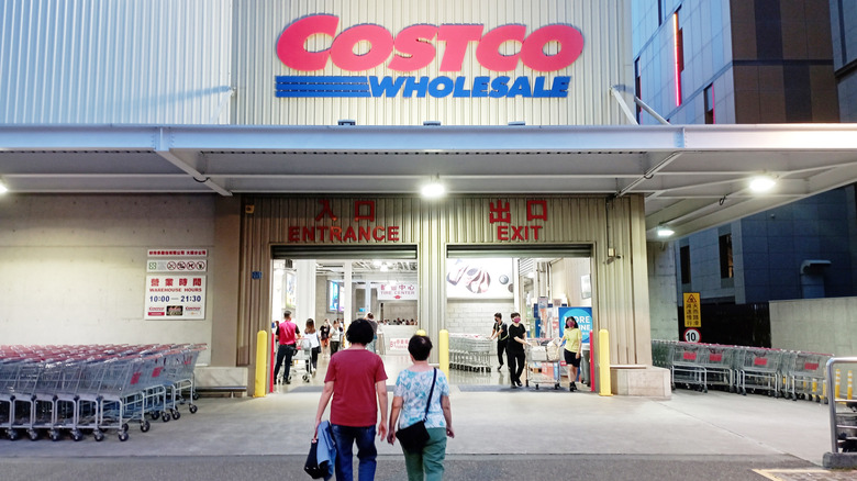 A couple entering Costco warehouse.