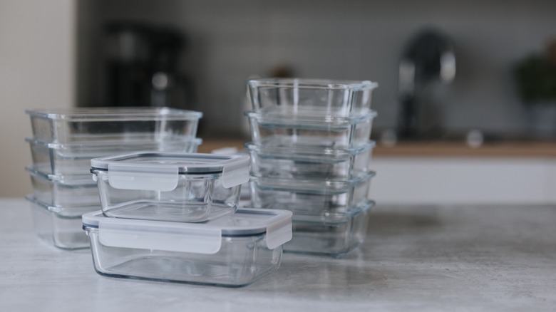 Multiple glass containers stacked in columns on a kitchen counter