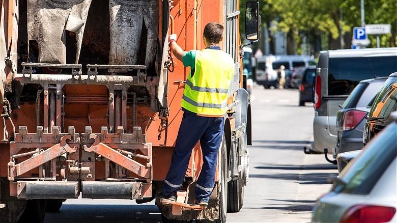 Garbage collector riding on truck