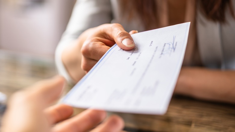 handing someone a salary check