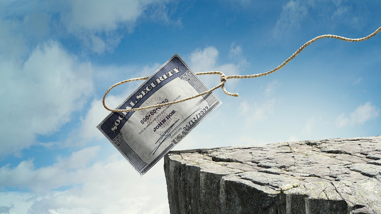 social security card falling over cliff edge