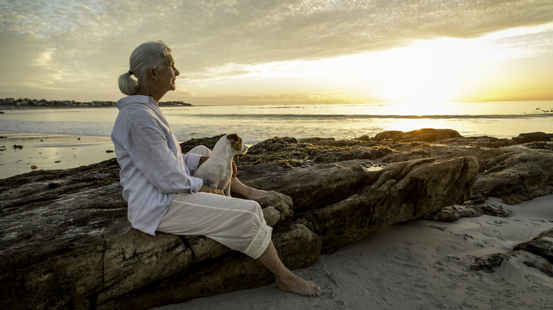 woman in retirement contemplating life on beach