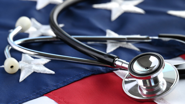 A stethoscope laying on a U.S. flag.