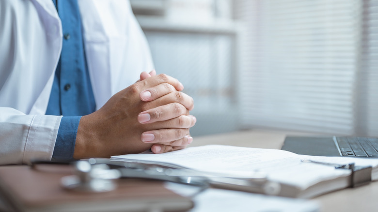 A doctor sitting at a desk