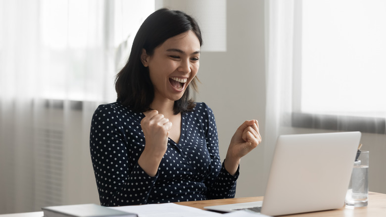 Person happy looking at computer