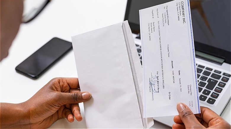 Person opening up paycheck
