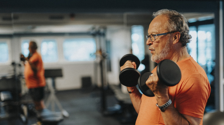 Older man lifting weights