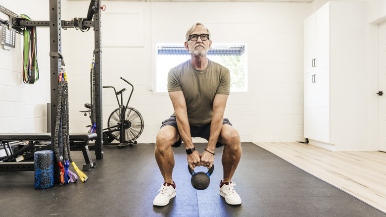 A mature man working out in home gym