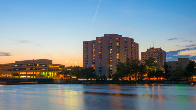 Rockford, Illinois skyline with Rock River in the foreground, at dusk, backlit.