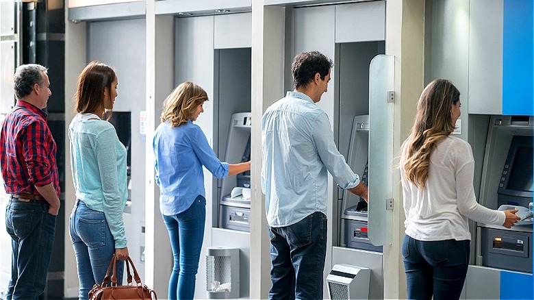People in front of ATMs