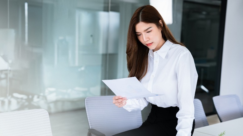 Person perusing document in office