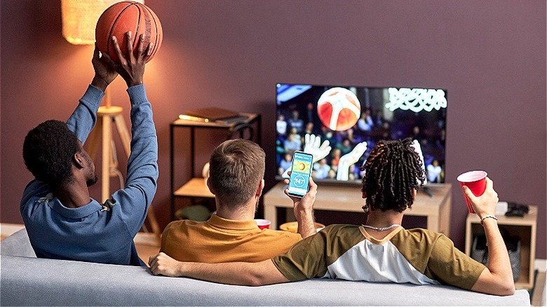 Group of friends betting basketball