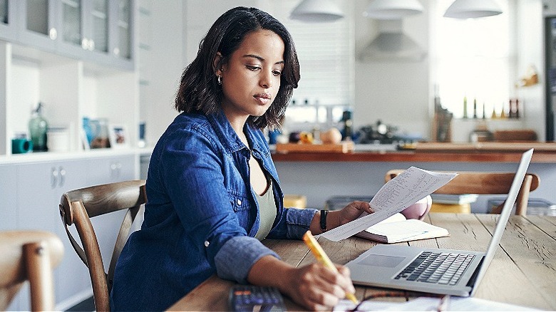 Person budgeting home expenses