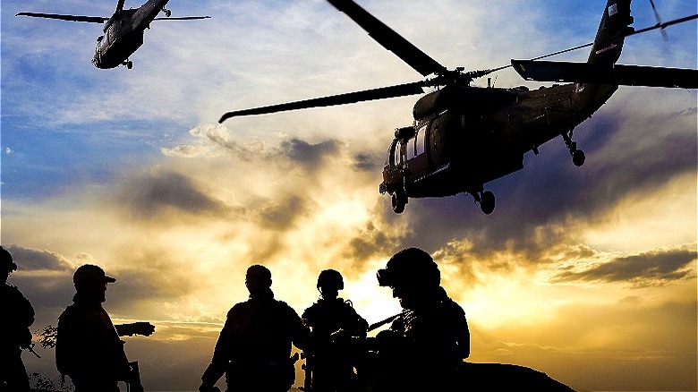 Soldier sillouhettes and helicopters