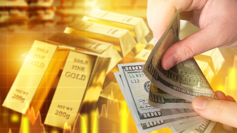 Money in the hand of a man with gold in the background