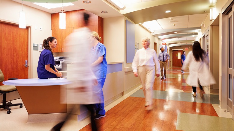 People walking about busy hospital