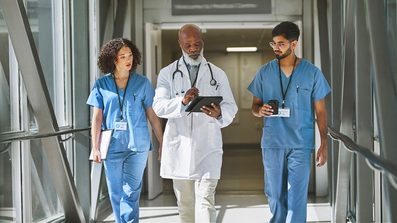 Doctor walking with two residents
