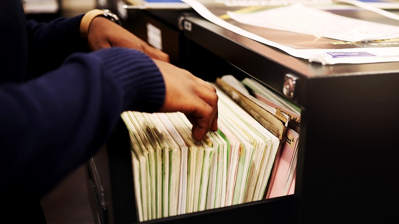 Person looking through filing cabinet