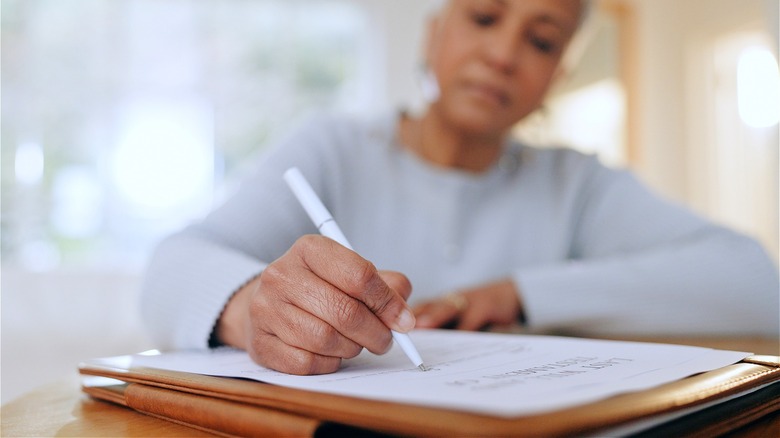 Person making home inventory list