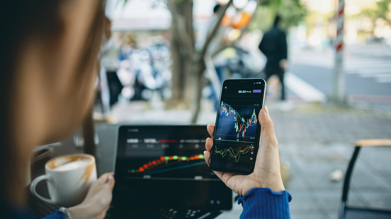 A woman checking stocks on her phone