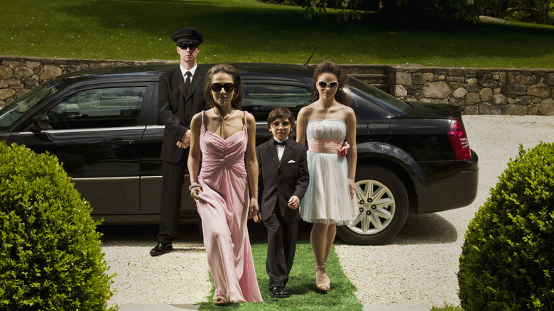 A family walking away from a limo