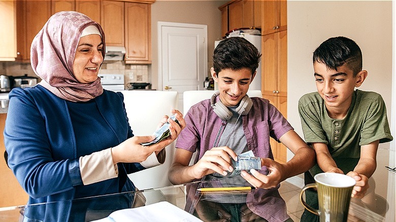 Mother reviews money with sons