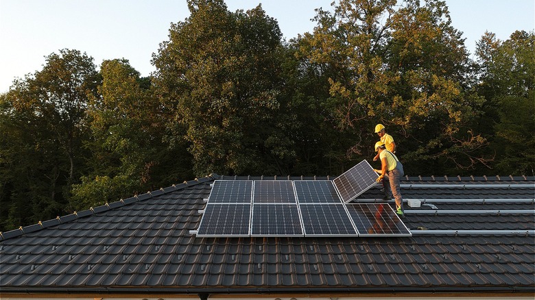 Workers installing solar panels
