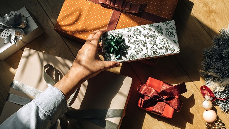 Person wrapping holiday gifts