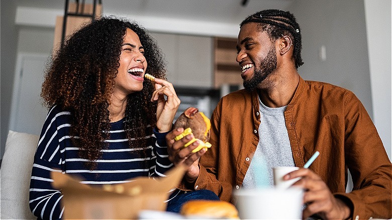 Young couple eating fast food
