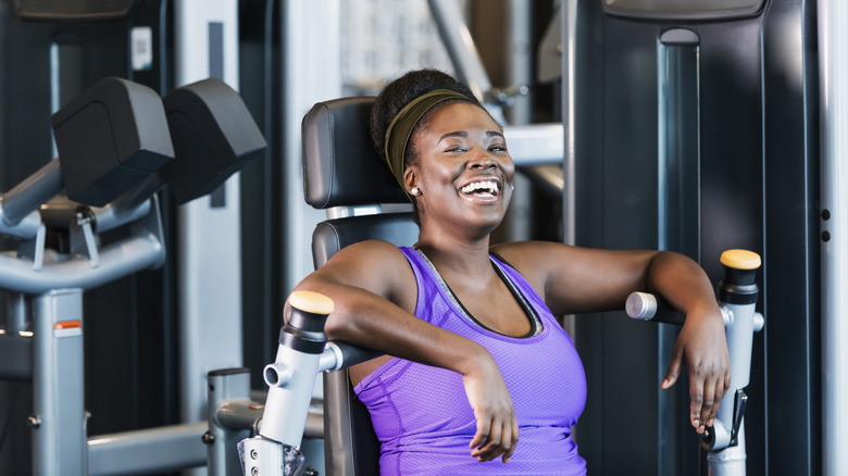 Gym member laughing on a machine