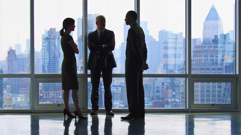 Businessperson looking out scenic window