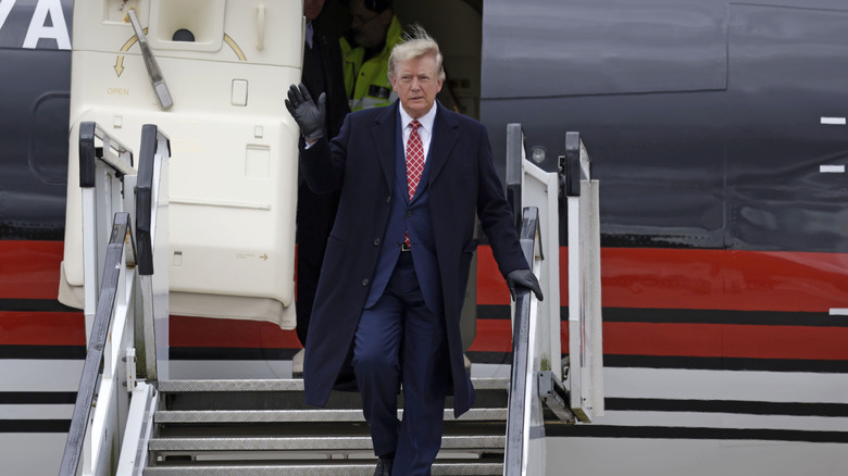 Trump stepping off of his plane