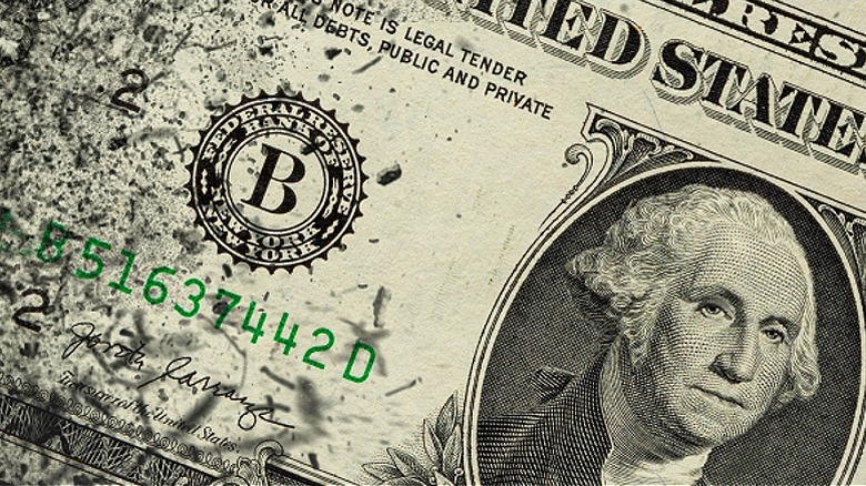 $1 bill breaking apart