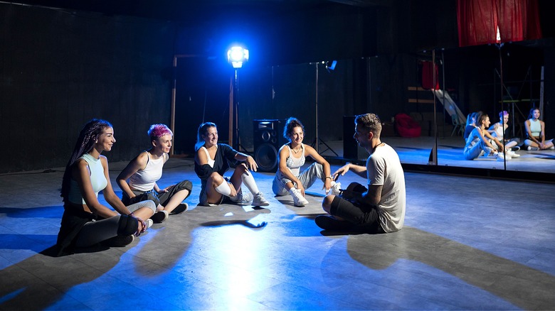 Dancers listening to their instructor