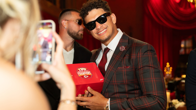 Patrick Mahomes holding his LVII Championship ring