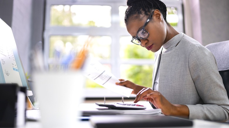 Person making calculations at desk