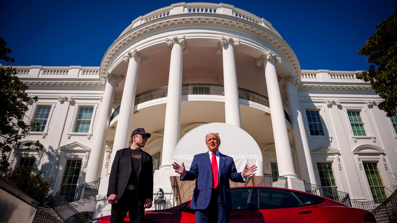 Elon Musk watches Trump promote Tesla cars in front of the White House.