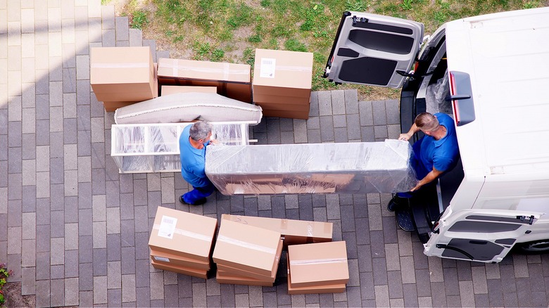 Movers moving furniture and boxes