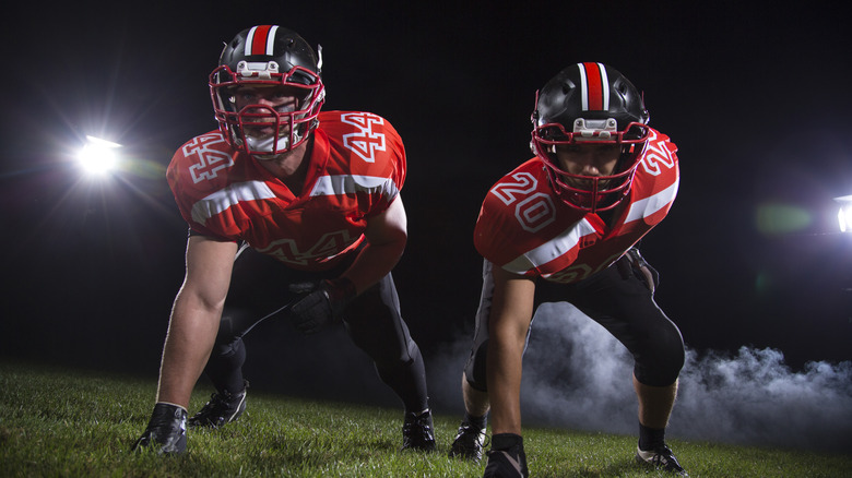 Football players on field at night
