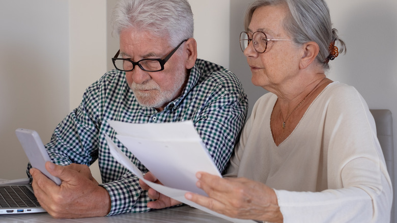 Senior couple looking at documents together at a desk