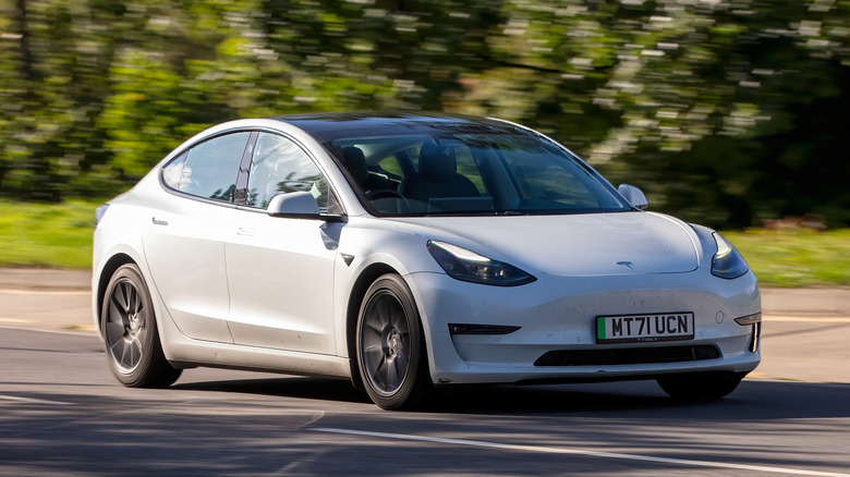 A white 2021 Tesla Model 3 on the road