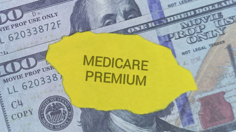 $100 bills and a medicare premium note