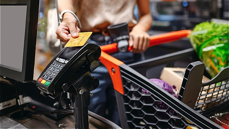 Person buying groceries with card